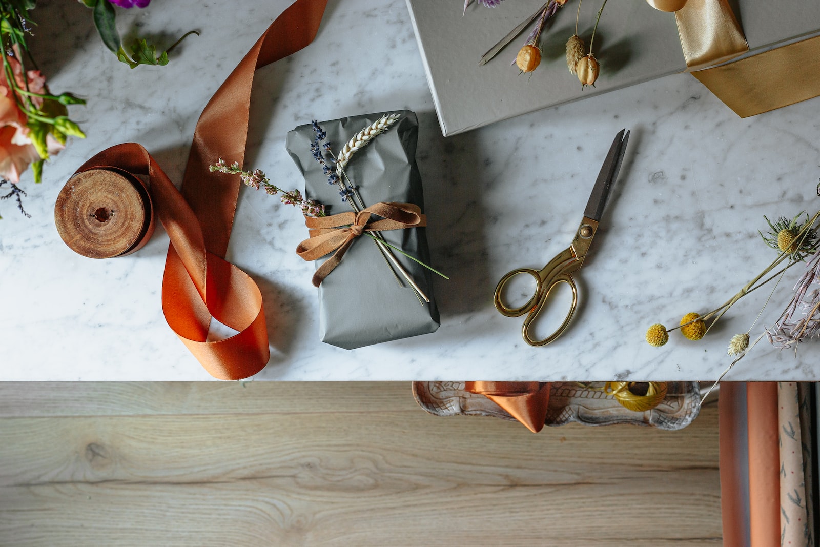 silver scissors beside orange leather shoe